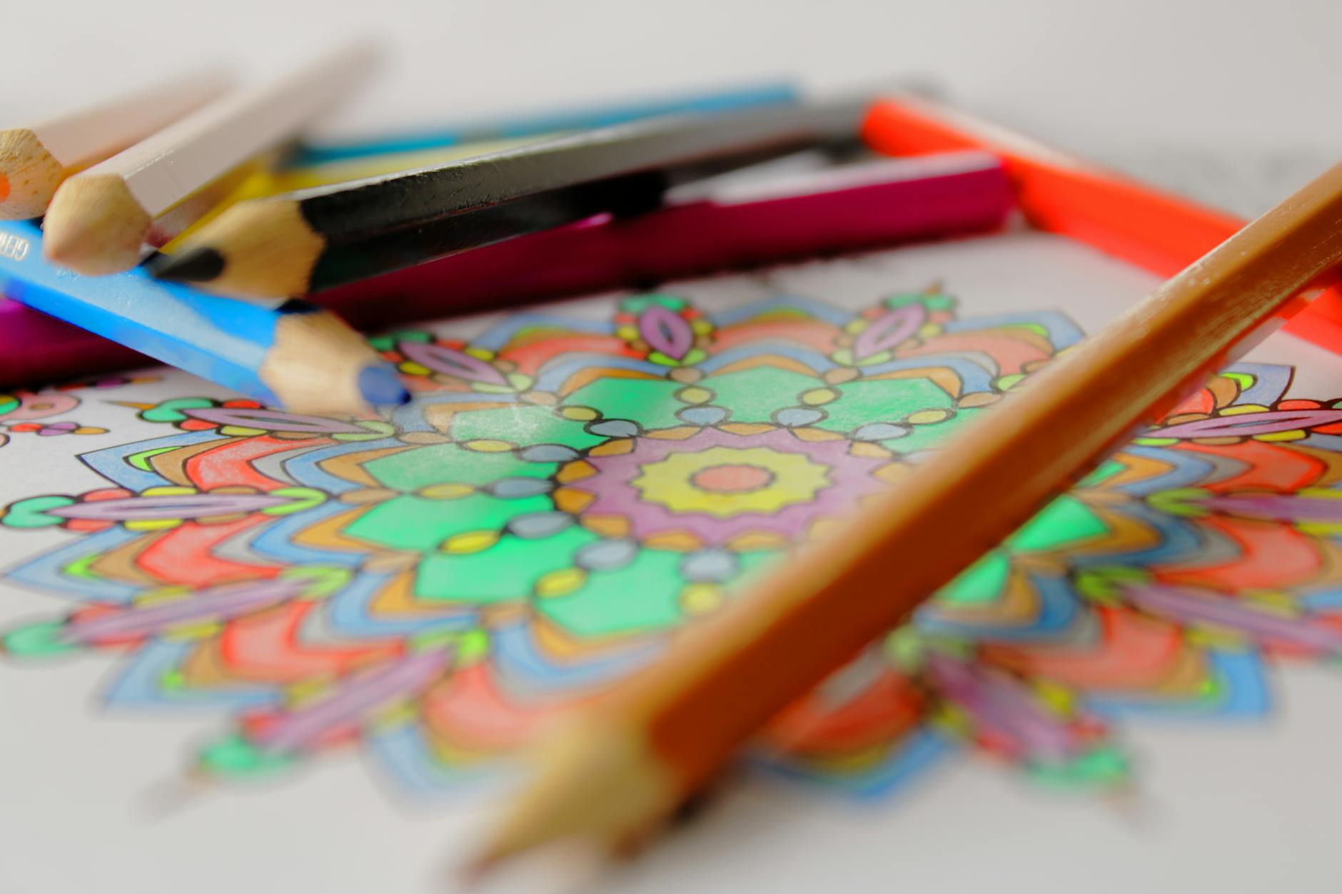 close up photo of colorful artwork and color pencils